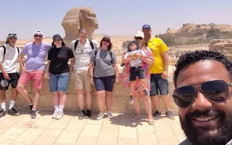 Group of tourists with guide at the Sphinx, part of Saqqara, Memphis, and Dahshur tour in Egypt.