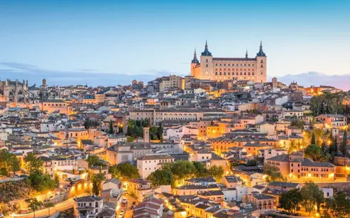 Toledo cityscape with Alcázar view, featured in self-guided walking tour on mobile app.
