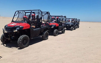 Family riding buggies on desert safari in Sharm El Sheikh's Echo Valley.