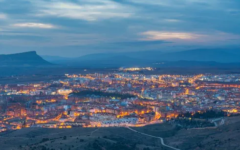 Soria cityscape at dusk, view from above, highlighting illuminated streets for self-guided walking tour.