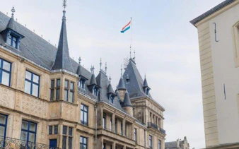 Luxembourg Palace with national flag on rooftop during self-guided audio walking tour.