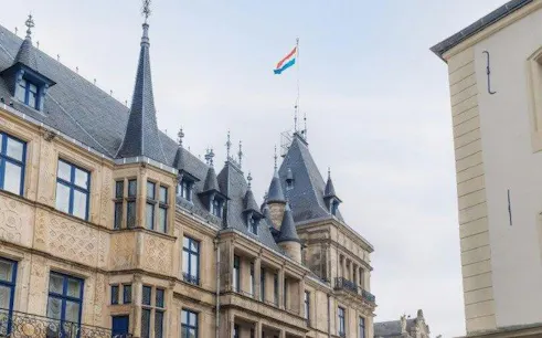 Luxembourg Palace with national flag on rooftop during self-guided audio walking tour.