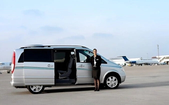 Van at Sharm El Sheikh airport with staff ready for hotel transfer.