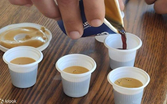 Pouring Cuban coffee into small cups during Little Havana walking tour in Miami.