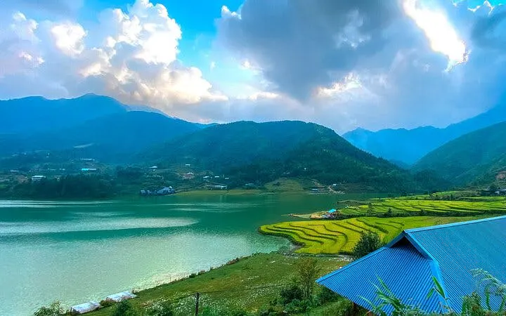 Sapa rice terraces and lake with mountain backdrop, Vietnam.