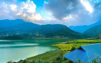Sapa rice terraces and lake with mountain backdrop, Vietnam.