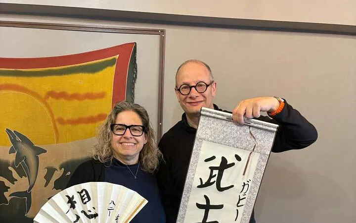Local instructor and participant display Japanese calligraphy in Yamanashi class near Mt. Fuji.
