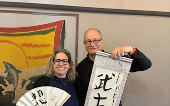Local instructor and participant display Japanese calligraphy in Yamanashi class near Mt. Fuji.