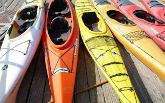 Kayaks lined up on a wooden dock for Key Largo Mangrove Kayak Adventure, Miami.
