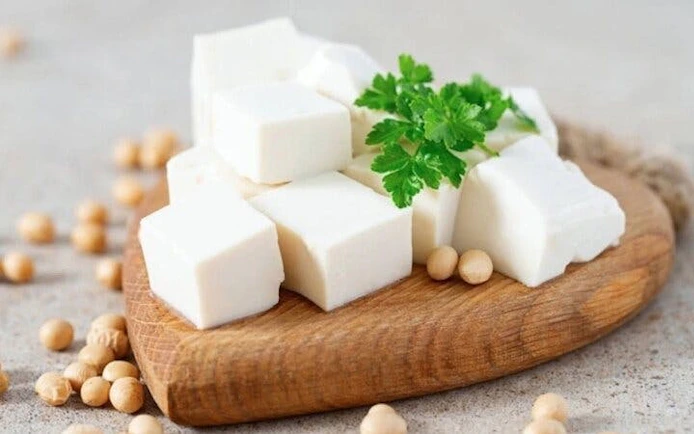Tofu cubes on a wooden board with soybeans, Sa Pa cooking class.