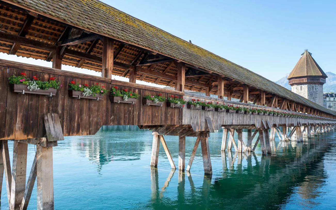 Chapel Bridge over Reuss River in Lucerne Old Town, part of self-guided audio walking tour.