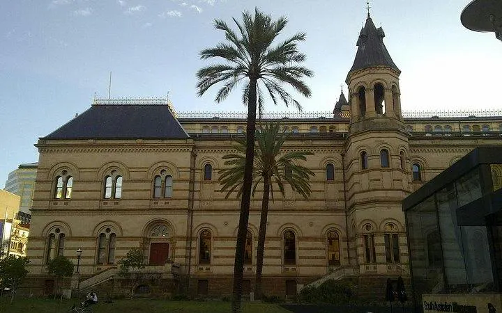 University of Adelaide historic building with palm trees, part of self-guided audio tour.