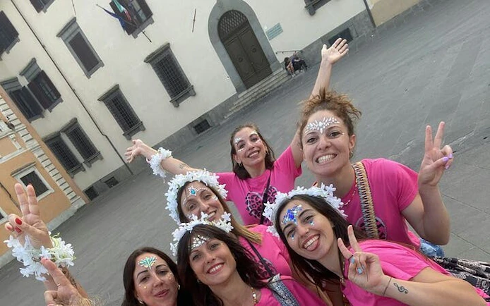 Group enjoying a self-guided city exploration game in Pisa, Italy.