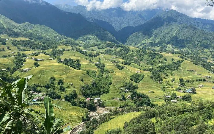 Sapa Muong Hoa Valley rice terraces and villages with mountains in the background.