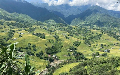Sapa Muong Hoa Valley rice terraces and villages with mountains in the background.