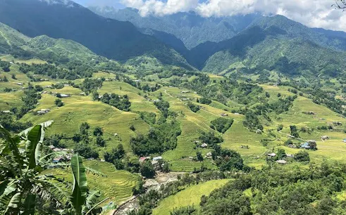 Sapa Muong Hoa Valley rice terraces and villages with mountains in the background.