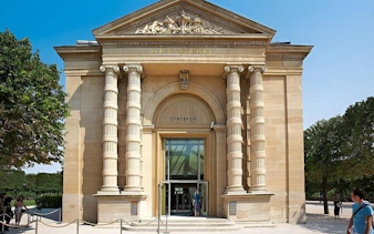Musée de l'Orangerie entrance in Paris with visitors outside.