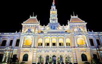 Ho Chi Minh City Hall illuminated at night, French colonial architecture, Ho Chi Minh City.