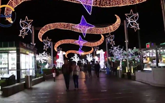 Soho Square Sharm El Sheikh illuminated at night with people walking.