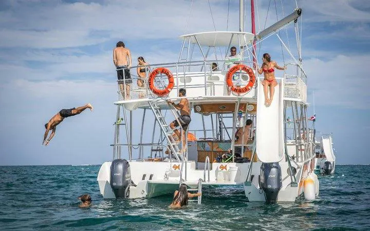 Snorkeling cruise with people diving and relaxing on a catamaran, Punta Cana.