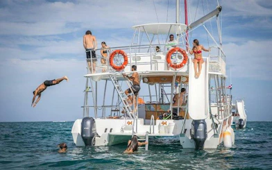 Snorkeling cruise with people diving and relaxing on a catamaran, Punta Cana.