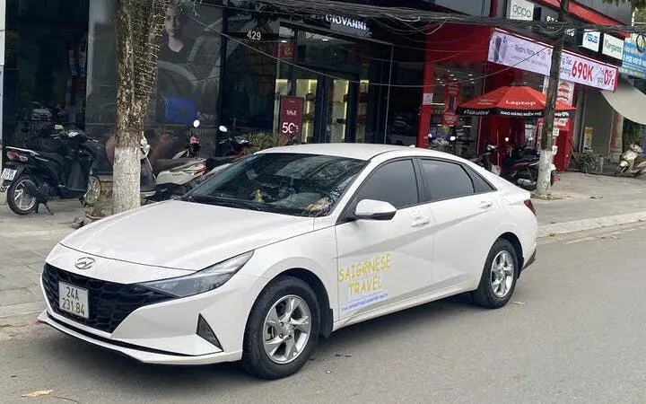 Private transfer car parked on a street in Vietnam for Sapa to Ninh Binh route.