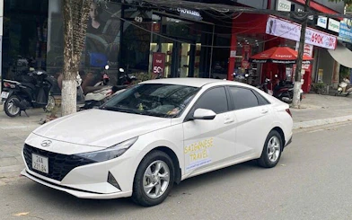Private transfer car parked on a street in Vietnam for Sapa to Ninh Binh route.