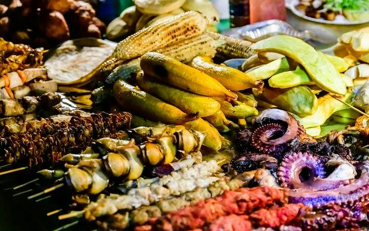 Street food display at Stone Town Zanzibar Night Food Market, featuring grilled seafood and local produce.