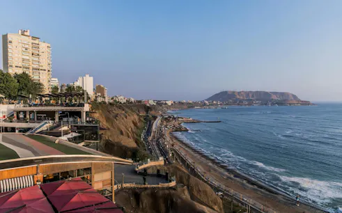 Cliff-top view of Larcomar and coastline in Miraflores, Lima.