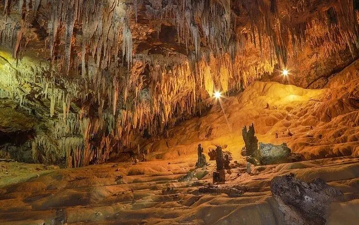 Cave interior with stalactites and stalagmites on Sapa Nature Day Trip.