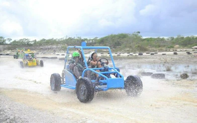 Off-road buggy driving through water in Punta Cana abandoned mine adventure.