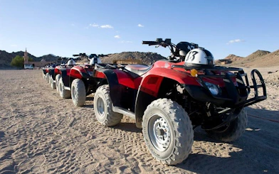 Quad bikes lined up on desert terrain for safari tour in Hurghada.