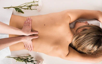 Massage session at Moroccan Hammam in Marrakesh with floral decor.