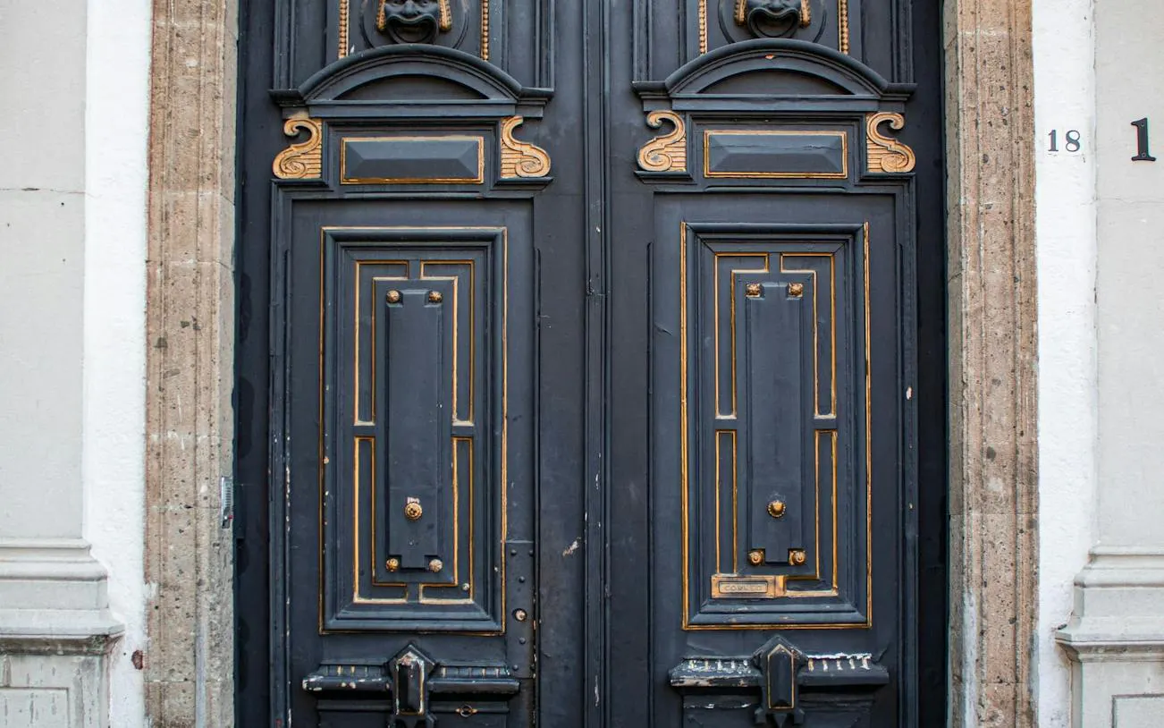 Ornate wooden door with gold accents in San Ángel, Mexico City.
