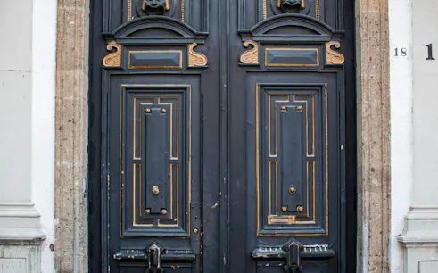 Ornate wooden door with gold accents in San Ángel, Mexico City.