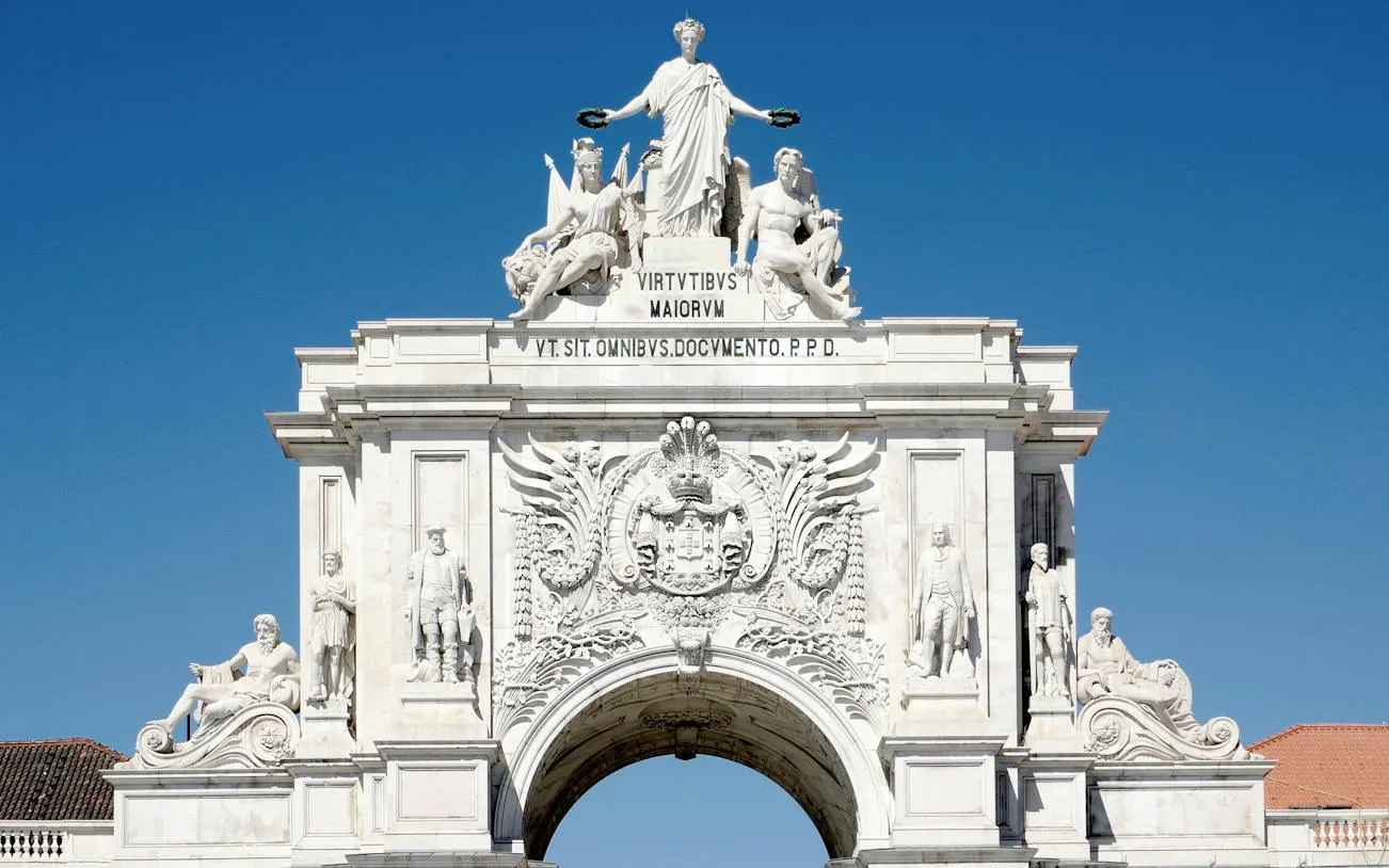 Rua Augusta Arch in Lisbon, featuring detailed sculptures, part of the Baixa and Chiado walking tour.