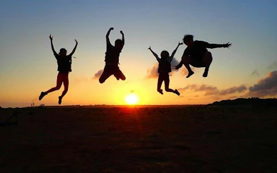 People jumping at sunset on Ishigaki Island, Okinawa during a SUP or canoe tour.