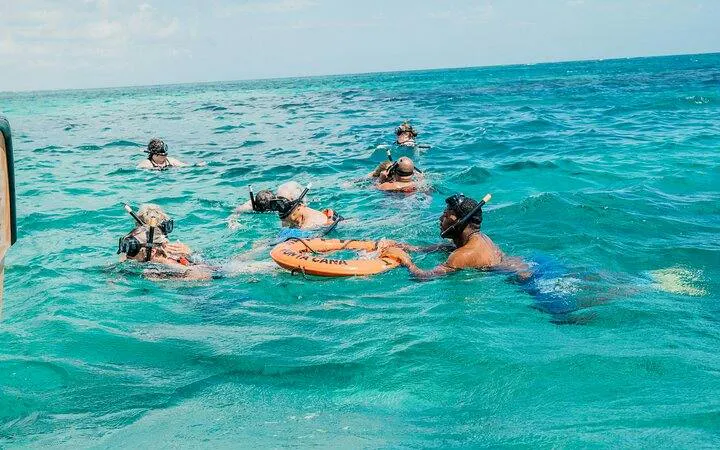 Snorkelers in turquoise water during catamaran cruise, Punta Cana.