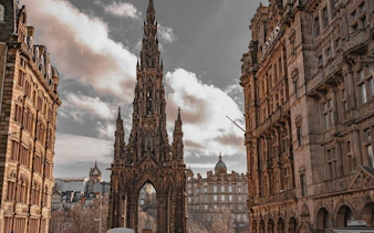 Scott Monument between historic buildings on Edinburgh walking tour.