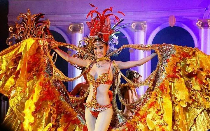 Performer in vibrant costume at Golden Dome Cabaret, Bangkok.