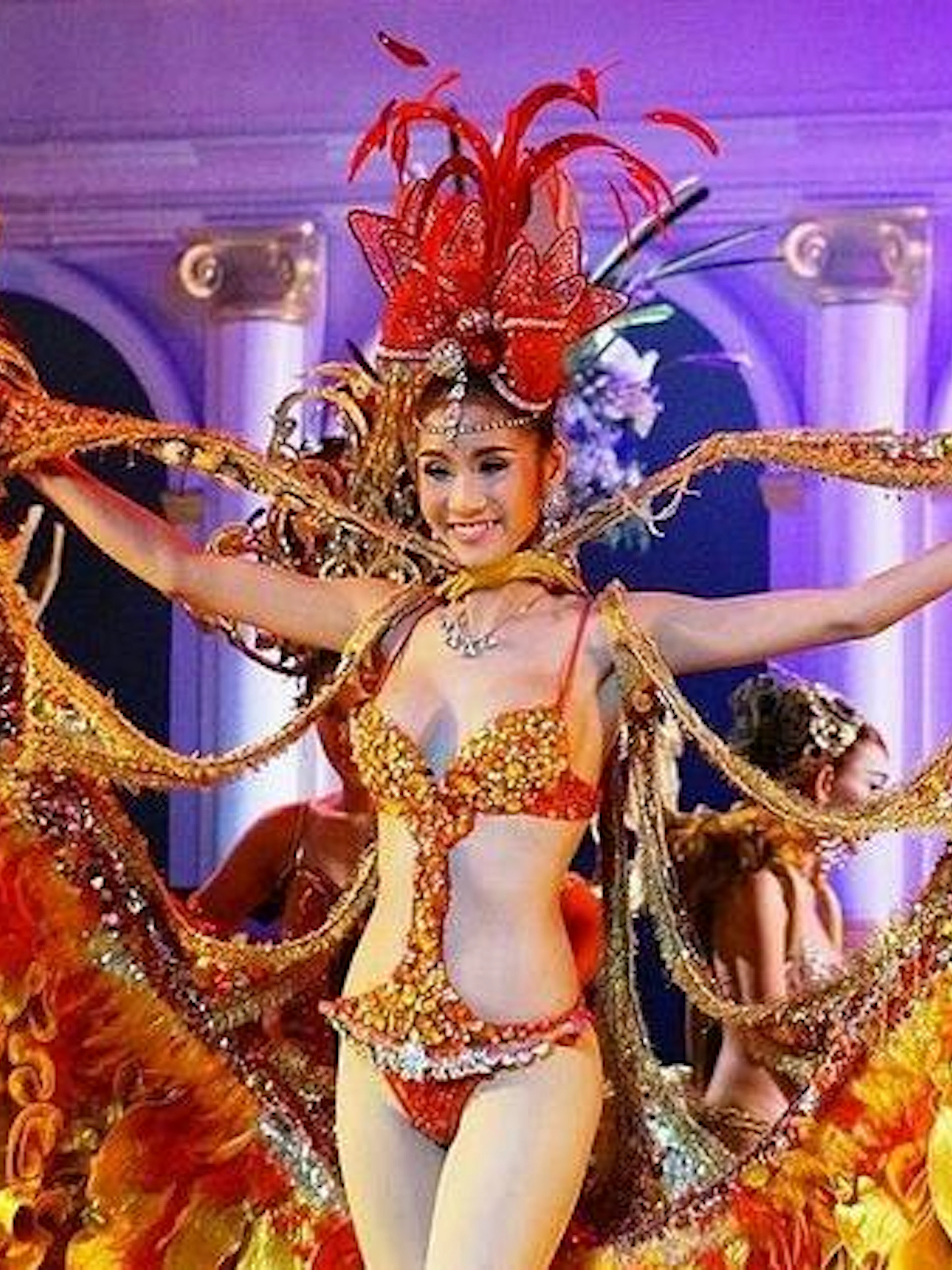 Performer in vibrant costume at Golden Dome Cabaret, Bangkok.