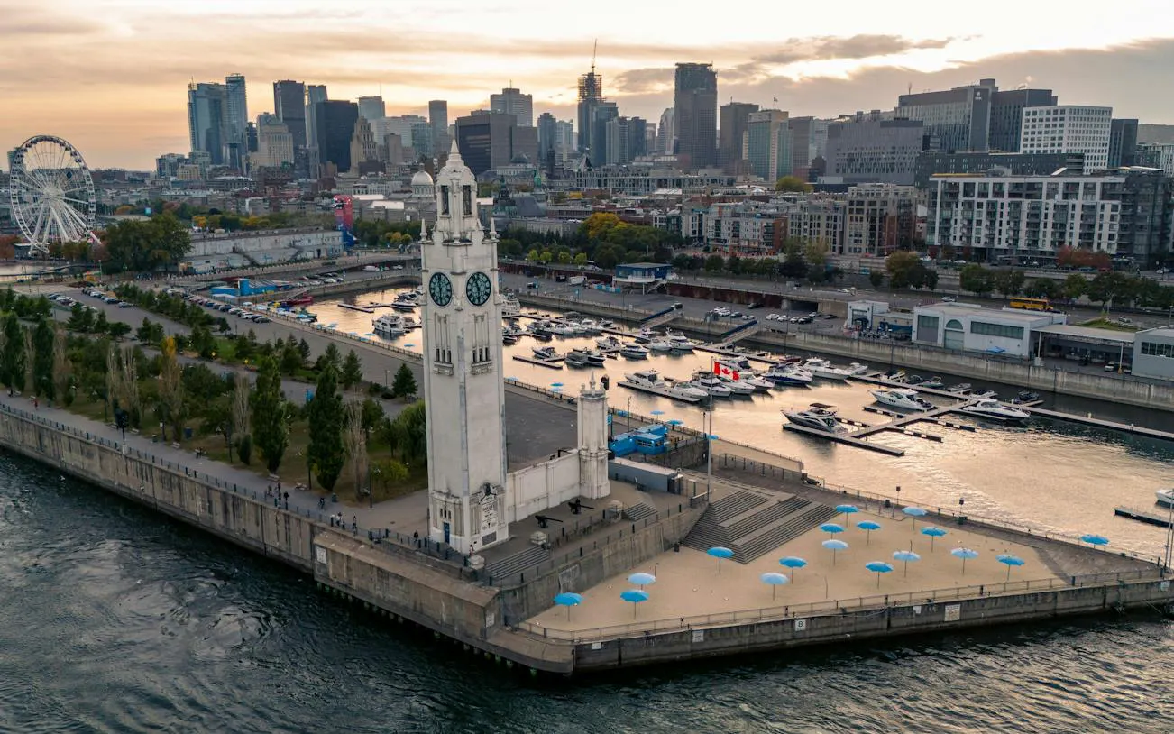 Clock Tower and marina at Old Port, Montreal, with city skyline in the background.