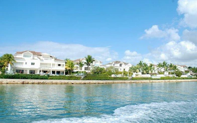 Marina Casa de Campo waterfront view with palm trees and luxury villas, Punta Cana.