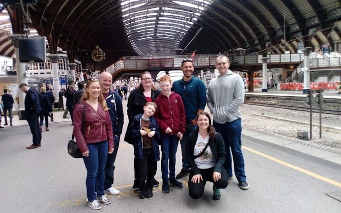 Group of tourists at York railway station during Harry Potter walking tour.