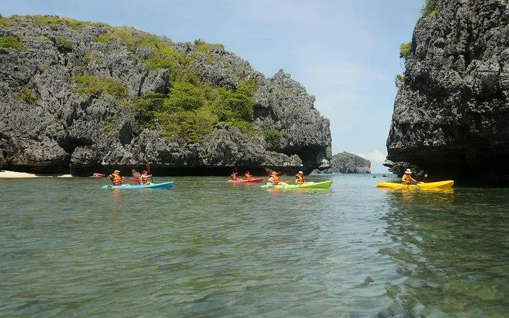 Kayakers exploring limestone cliffs at Ang Thong National Marine Park, Koh Samui.