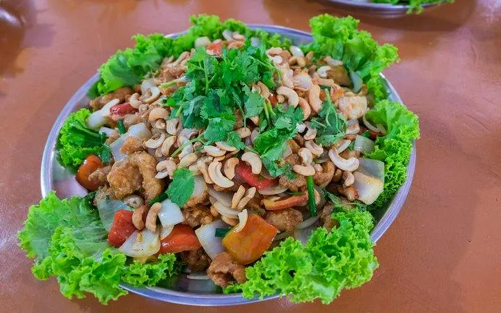 Thai dish with cashews and vegetables served on a plate, Phang Nga Bay tour, Phuket.