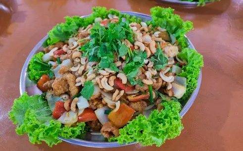 Thai dish with cashews and vegetables served on a plate, Phang Nga Bay tour, Phuket.