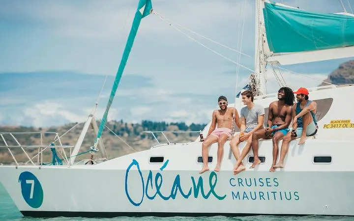 Catamaran with group enjoying cruise near Benitiers Island, Mauritius.