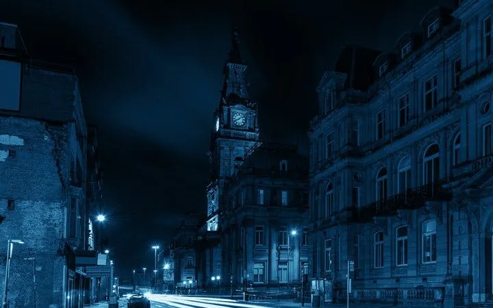 Liverpool street at night with historic clock tower, part of haunted city exploration game.