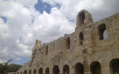 Odeon of Herodes Atticus under cloudy sky, part of Athens evening walking tour.